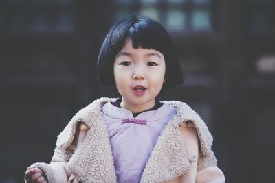 Portrait of cute girl wearing warm clothing