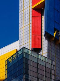 Low angle view of modern building against blue sky