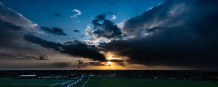 Scenic view of dramatic sky over land