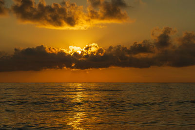 Beautiful warm sunset over the sea in orange tones