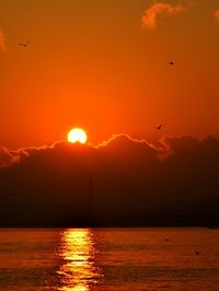 Scenic view of sea against orange sky