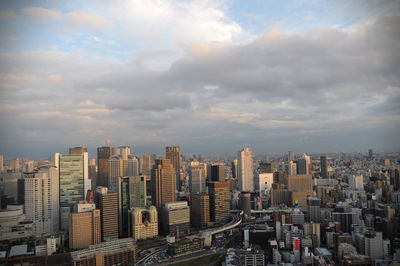 Osaka cityscape against cloudy sky