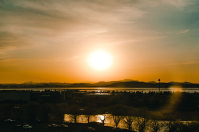 Scenic view of lake against sky during sunset