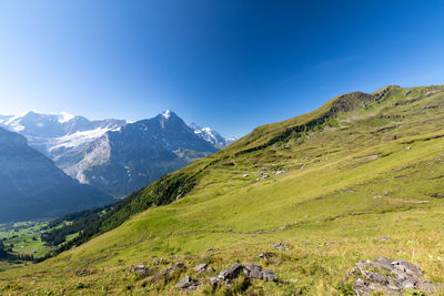 Scenic view of mountains against clear blue sky