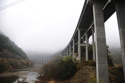 Low angle view of bridge covered with fog