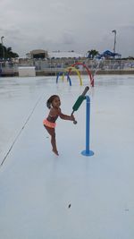 Full length of girl playing in the sky