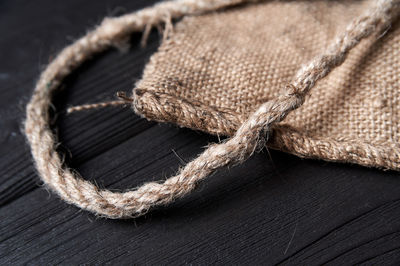 Close-up of rope tied on wood