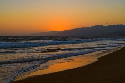 Scenic view of sea against clear sky during sunset