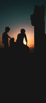 Silhouette people against sky during sunset