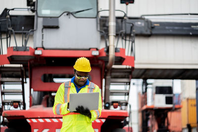 Engineer using laptop at construction site