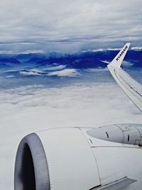 Cropped image of airplane wing over landscape