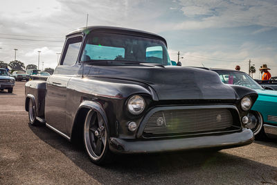 Vintage car parked on road against sky