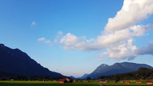 Panoramic view of landscape and mountains against blue sky