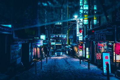 Illuminated city street at night