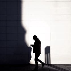 Full length of woman standing on wall