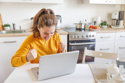 Boy using laptop at home