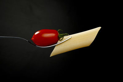 Close-up of strawberry over black background