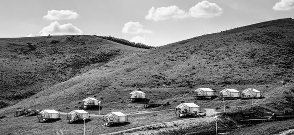 Houses on field against sky