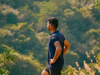 Side view of man standing on mountain