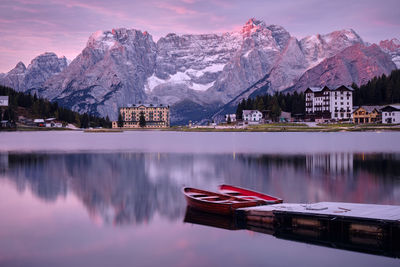 Scenic view of lake by snowcapped mountains against sky