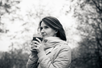 Portrait of young woman drinking coffee