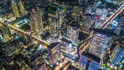 High angle view of city lit up at night