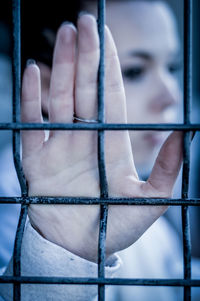 Close-up of human hand on metal structure in building