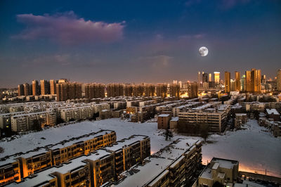 Aerial view of buildings in city during winter