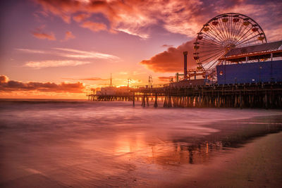 Pier on sea at sunset