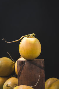 Close-up of apple on table against black background