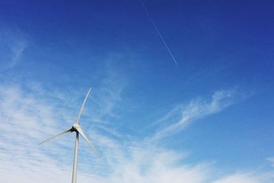 Low angle view of vapor trail against blue sky