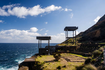 Lifeguard hut by sea against sky