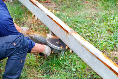 Low section of man working on field