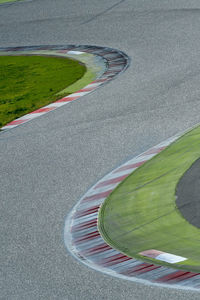 High angle view of curvy road amidst field