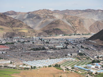 High angle view of buildings and mountains against sky