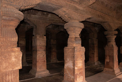 Badami cave sculptures of hindu gods carved on roof ancient stone art in details