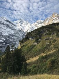 Scenic view of mountains against cloudy sky