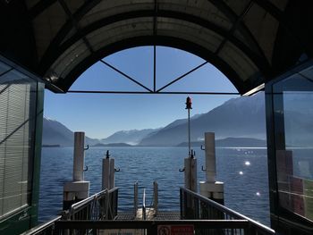 Scenic view of river and mountains seen through jetty