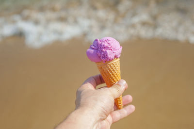 Hand holding ice cream cone