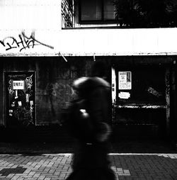 Rear view of man walking on road