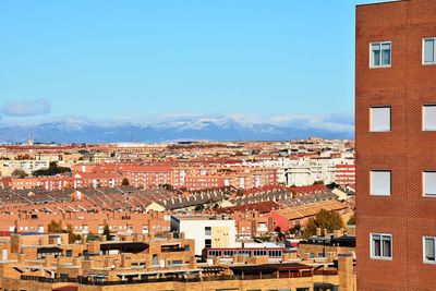 View of residential district against blue sky