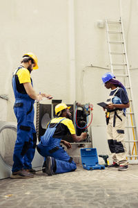 Side view of people working at construction site