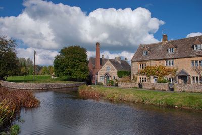 Panoramic view of river amidst buildings against sky