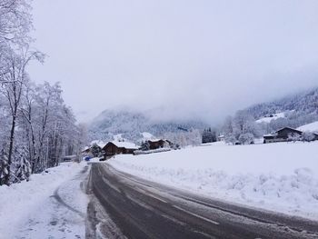 Snow covered landscape against clear sky