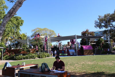 People at park against clear sky