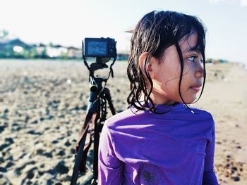 Midsection of woman with bicycle on beach