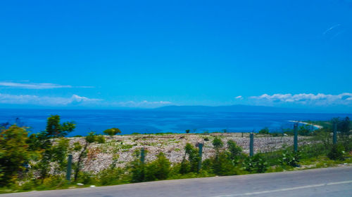 Scenic view of sea against blue sky