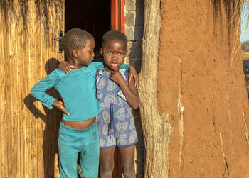 Boy standing against wall