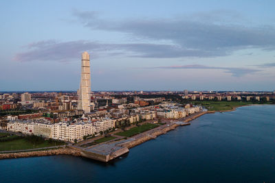 Aerial view of modern skyline in malmo city against sky during sunset