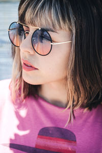 Close-up portrait of woman wearing sunglasses